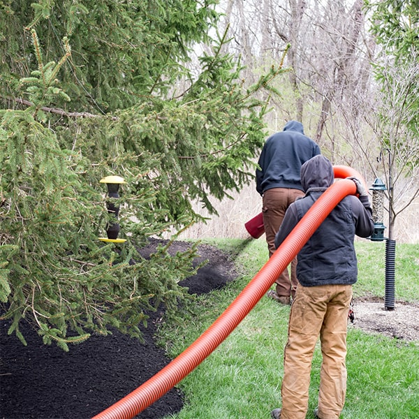 mulch blowing involves using equipment to evenly distribute mulch across a designated area